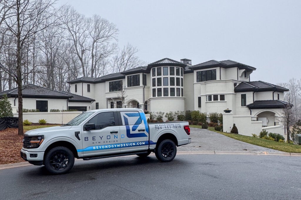 Beyond Gym Design Truck in front of luxury custom home